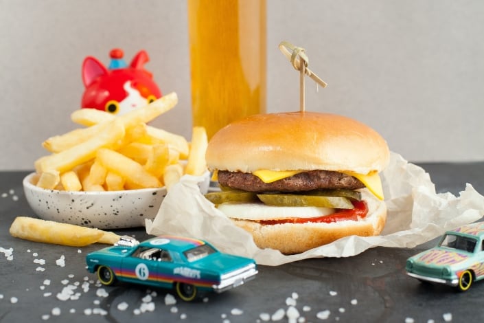 burger and fries surrounded by toys